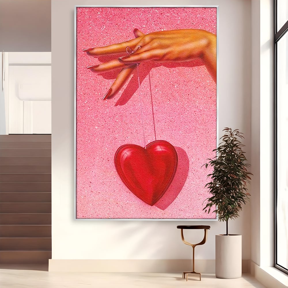 Tablou canvas cu ilustratie cu mana care tine o inima rosie, in rama de aluminiu argintiu